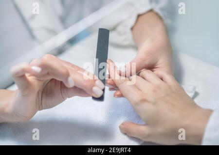 Nahaufnahme von Nagelkünstler Hände tun Maniküre Stockfoto