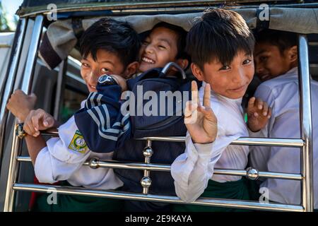 Die Schüler, von denen die meisten Waisenkinder sind, die aus dem Bürgerkrieg geflohen sind, werden in Myikyina, Myanmar, wieder zur staatlichen Schule gefahren. Stockfoto