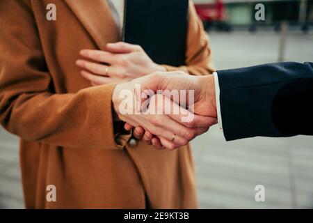 Nahaufnahme von Kollegen, die sich die Hände schüttelten, um den Geschäftsabschluss zu beenden Stockfoto