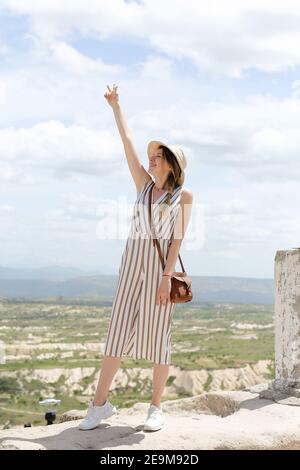 Mädchen steht auf Felsen, schöne Landschaft im Hintergrund, Kappadokien. Stockfoto