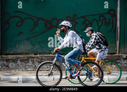 Yangon, Burma. Februar 2021, 05th. Radfahrer fahren Fahrräder während der Demonstration gegen den Militärputsch gestikulierte. Das Militär von Myanmar nahm am 01. Februar 2021 die staatliche Beraterin von Myanmar Aung San Suu Kyi fest und erklärte den Ausnahmezustand, während sie die Macht im Land für ein Jahr ergattete, nachdem sie die Wahl gegen die National League for Democracy (NLD) verloren hatte. Kredit: SOPA Images Limited/Alamy Live Nachrichten Stockfoto