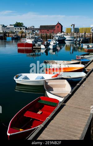 Bunte Ruderboote in der berühmten Bradley Wharf, die von der beliebten roten Fischerhütte, bekannt als Motif #1, in Rockport Harbor in Massachusetts, vertäut sind. Stockfoto