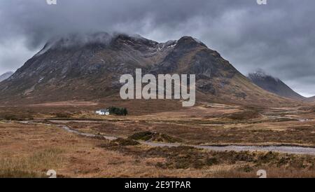 Atemberaubende Landschaftsaufnahme im Glencoe Valley in den schottischen Highlands Mit Bergketten in dramatischer Winterbeleuchtung Stockfoto