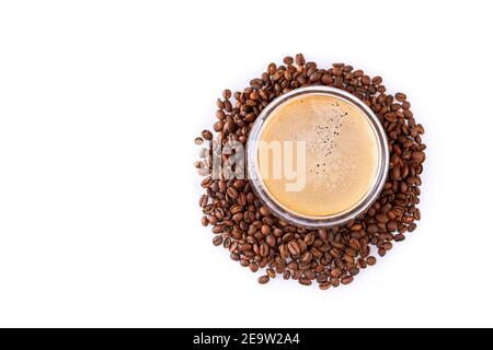 Espresso mit dickem Schaum auf Kaffeebohnen isoliert auf weißem Hintergrund. Blick von oben Stockfoto