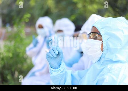 Die indischen Ärzte tragen PPE und eine Diskussion im Freien Stockfoto