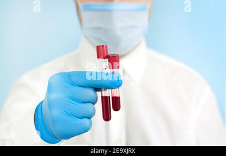 Techniker für Gesundheit hält Blutprobenröhrchen im medizinischen Labor Für die Forschung Stockfoto