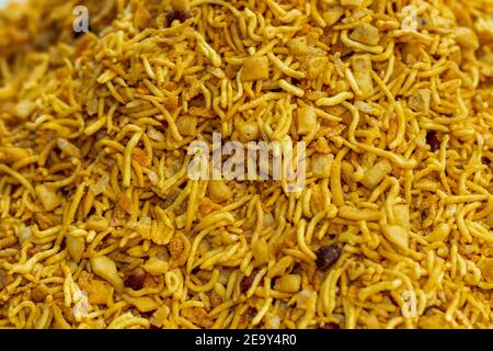 Chanachur oder Dal Motte, Sev Namkeen, bhujia, Crispy Aloo Bhujia, mit einer Nuss in einem ländlichen Markt für den Verkauf und ein Junk-Street-Food Stockfoto