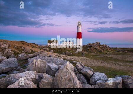 Portland Bill, Dorset, Großbritannien. 6th. Februar 2021. Wetter in Großbritannien. Der Himmel leuchtet orange über dem Leuchtturm bei Portland Bill in Dorset am Ende eines Tages voller Sonneneinflüsse während der Covid-19-Sperre. Bild: Graham Hunt/Alamy Live News Stockfoto