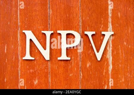 Alphabet letter in word NPV (Abbreviation of net present value) on old red color wood plate background Stockfoto