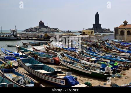 Kanyakumari, Tamil Nadu, Indien - Januar, 2017: Fischerboote am Strand und Blick auf die Thiruvalluvar Statue Stockfoto