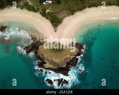 Von oben aus der Drohne blickt man auf eine herzförmige tropische Bucht mit kristallklarem türkisfarbenem Wasser und weißem Sandstrand in Nusa Penida, Bali, Indonesien. Stockfoto