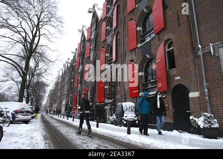 Amsterdam, Niederlande. Februar 2021, 07th. Am Prinsengracht-Kanal geht man inmitten der Coronavirus-Pandemie am 7. Februar 2021 in Amsterdam, Niederlande, durch den Schnee. Das niederländische Wetterbüro gab einen Code Red Weather Storm Darcy bringen starken Schneefall und kalten Winden Warnung für viele Orte als die erste seit 2010 traf die Niederlande. (Foto von Paulo Amorim/Sipa USA) Quelle: SIPA USA/Alamy Live News Stockfoto