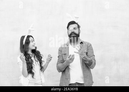 Ei jonglieren. Spaß bei der Ostereierjagd. Fröhliche Familie bereitet sich auf Ostern vor. Glückliche Familienzeit. Vater und Tochter feiern Ostern. Lächelnd und lachend. Kaninchenparty. Feiertag vorbereiten. Stockfoto