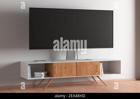 TV-Breitbildschirm auf dem TV-Ständer im modernen Wohnzimmer mit weißer Wand. Seitenansicht Stockfoto