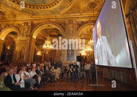 Ein großes Publikum hört im Hotel de Ville von Paris um drei Uhr morgens auf einer Großleinwand live auf T.V, Paris Bürgermeister Bertrand Delanoe hält seine Rede bei der Paris-Stadtpräsentation im Raffles City Convention Center in Singapur am 6. Juli 2005. Das Internationale Olympische Komitee wird später am Tag darüber abstimmen, ob London, Paris, New York, Madrid oder Moskau die Olympischen Spiele 2012 ausrichten werden. Foto von Christophe Guibbaud/Cameleon/ABACAPRESS.COM Stockfoto