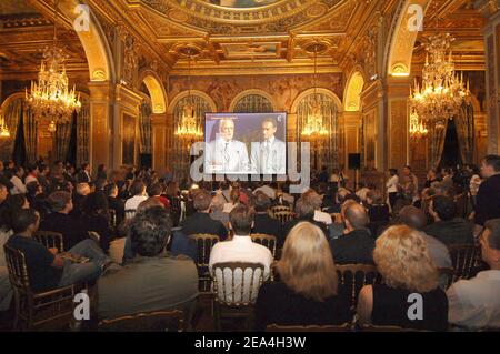 Ein großes Publikum hört im Hotel de Ville von Paris um drei Uhr morgens auf einer Großleinwand live auf T.V, Paris Bürgermeister Bertrand Delanoe hält seine Rede bei der Paris-Stadtpräsentation im Raffles City Convention Center in Singapur am 6. Juli 2005. Das Internationale Olympische Komitee wird später am Tag darüber abstimmen, ob London, Paris, New York, Madrid oder Moskau die Olympischen Spiele 2012 ausrichten werden. Foto von Christophe Guibbaud/Cameleon/ABACAPRESS.COM Stockfoto