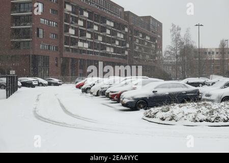 Autos gesehen geparkt auf der schneebedeckten Straße. Blizzard von Schneesturm Darcy trifft die Niederlande, der erste heftige Schneefall mit intensiven starken Winden nach 2010. Das Land erwachte am Sonntag mit einer Schneeschicht, die alles bedeckte. Viele Unfälle ereigneten sich auf den niederländischen Straßen aufgrund des Sturms und der eisigen Bedingungen, während es auch ein Problem mit den Zügen gab. In der Stadt Eindhoven in Nordbrabant wurde der Bahn- und Busverkehr eingestellt, der Flughafen folgte und der Flugverkehr umgeleitet. Die Menschen gingen in die Innenstadt von Eindhoven, um die weiße Landschaft zu genießen und einige nutzten ihren Schlitten Stockfoto