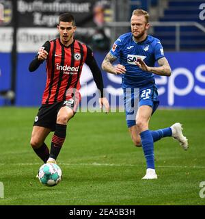 Hoffenheim. Februar 2021, 8th. Andre Silva (L) aus Frankfurt spielt mit Kevin Vogt aus Hoffenheim während eines Bundesliga-Fußballspiels zwischen Frankfurt und Hoffenheim in Hoffenheim, Deutschland, 7. Februar 2021. Quelle: Xinhua/Alamy Live News Stockfoto