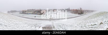 Ultra-weite Panorama-Ansicht von Den Helder vom Deich aus, während eines Schneesturms Stockfoto
