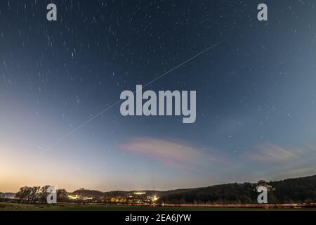 Long time exposure of International Space Station ISS during sunset in Bavaria with Walhalla near Regensburg in background, Germany Stockfoto