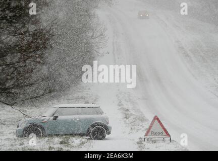 Uppingham, Rutland, Großbritannien. 8th. Februar 2021. Wetter in Großbritannien. Ein gestrandetes Auto steht auf dem Grund eines schneebedeckten Hügels. Credit Darren Staples/Alamy Live News. Stockfoto