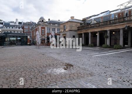 Mit sehr wenigen Menschen aus und über die Szene in Covent Garden piazza ist eine der leeren Verwüstung, wie die nationale Coronavirus Lockdown drei am 29th. Januar 2021 in London, Großbritannien. Nach der Zunahme der Fälle im Winter, einschließlich einer neuen britischen Variante von Covid-19, rät diese landesweite Sperre allen Bürgern, der Botschaft zu folgen, zu Hause zu bleiben, den NHS zu schützen und Leben zu retten. Stockfoto