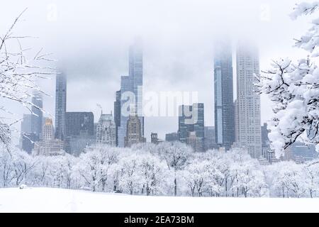 Leerer Central Park während eines wunderschönen Schneesturms mit Blick auf die Stadt. Stockfoto