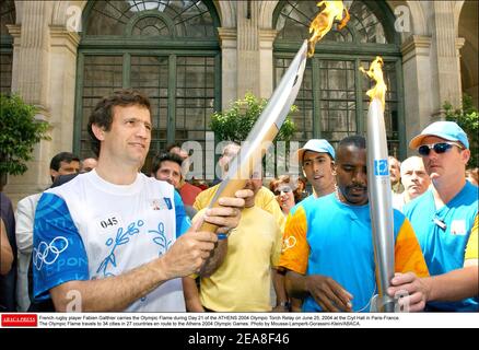 Der französische Rugby-Spieler Fabien Galthie trägt die olympische Flamme am 21. Tag des OLYMPISCHEN Fackellaufs 2004 in ATHEN am 25. Juni 2004 im Rathaus in Paris-Frankreich. Die Olympische Flamme reist zu den Olympischen Spielen 2004 in Athen in 34 Städte in 27 Ländern. Foto von Mousse-Lamperti-Gorassini-Klein/ABACA. Stockfoto