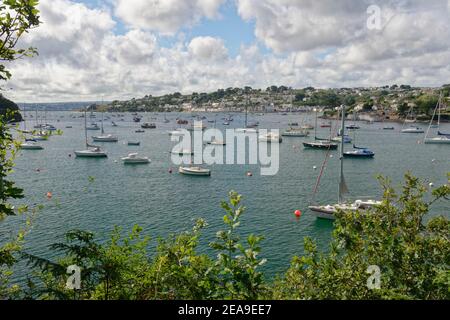 Blick über den Hafen von St. Mawes mit vielen festlegenen Segelyachten nach St. Mawes vom Southwest Coast Pfad in der Nähe von St. Anthony in Roseland, Cornwall, Großbritannien. Stockfoto