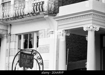 Großbritannien, West London, Notting Hill, 1973. Heruntergekommene und heruntergekommene, große, vierstöckige Häuser werden langsam restauriert und neu dekoriert. Kaputtes Fensterglas im Haus (Nr.9 oder 10) neben dem Talbot Tabernakel Seiteneingang in Powis Gardens. Stockfoto