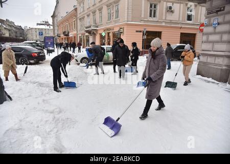 Lviv, Ukraine. Februar 2021, 08th. Eine Frau räumt mit einer Schaufel Schnee auf den Straßen von Lemberg.in den vergangenen 24hrs sind in Lemberg mehr als 30cm Schnee gefallen. Aufgrund der Tatsache, dass die öffentlichen Versorgungsunternehmen es nicht schaffen, Schnee zu entfernen, nahmen Einwohner von Lemberg auf die Straßen, um Schnee von schweren Schneefällen angehäuft zu reinigen. Kredit: SOPA Images Limited/Alamy Live Nachrichten Stockfoto