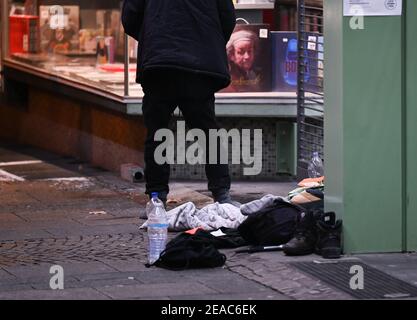 08. Februar 2021, Hessen, Frankfurt/Main: Ein Obdachloser hat heute Abend vor dem verschlossenen Eingang der Kleinmarkthalle in der Frankfurter Innenstadt ein Lager aufgeschlagen. Angesichts von Schnee und Kälte ist die Situation der Obdachlosen gefährlich. Foto: Arne Dedert/dpa Stockfoto