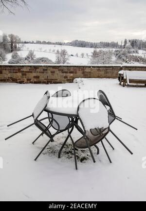 Gartenstühle und Gartentisch im Winter, Schnee, Absperrung Stockfoto
