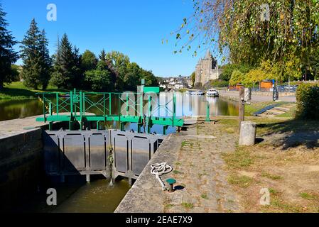 Fluss Oust, Teil des Kanals Nantes bei Brest, mit seiner Schleuse und Schloss im Hintergrund bei Josselin in Frankreich Stockfoto