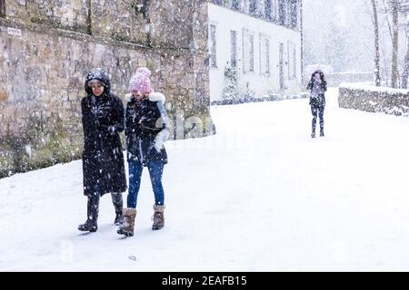 Edinburgh, Großbritannien. 09. Februar 2021 im Bild: Wanderer kämpfen gegen den fahrenden Schnee, während ein anderer Wanderer die winterliche Szene auf ihrem Handy einfängt. Kredit: Rich Dyson/Alamy Live Nachrichten Stockfoto