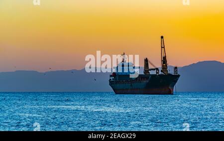 Sonnenuntergang Ansicht eines Frachtschiffes am golf von aqaba, Jordanien Stockfoto