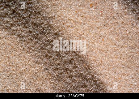 Nahaufnahme Textur des Sandstrandes aus der Draufsicht für Hintergrund des Hintergrundbilds Stockfoto