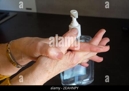Hydro-alkoholisches Gel auf die Hände einer Frau legen Stockfoto
