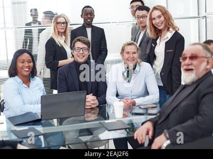 Multinationale Arbeitsgruppe, die am Büroschalter sitzt. Stockfoto