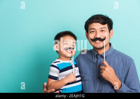 Familie lustig glücklich Hipster Vater und sein Sohn Kind halten Schwarze Schnurrbart Requisiten Stockfoto