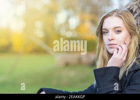 Coole junge Frau posiert im Herbstpark Stockfoto