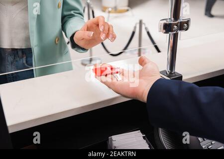 Kurzer Blick auf die Rezeptionistin, die der Frau im Hotel den Schlüssel gab Stockfoto