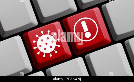 Covid-19 Warnsymbole auf roter Computertastatur Stockfoto