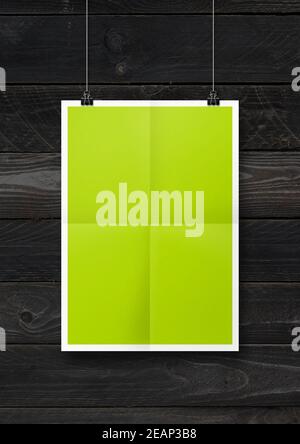 Limgrün gefaltetes Poster an einer Betonwand mit Clips Stockfoto
