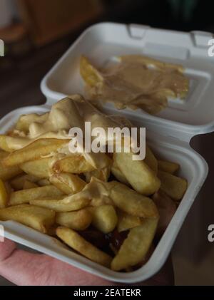 currywurst mit Pommes in eine Tasse. Traditionelle deutsche Küche mit Dip zu Corona Zeiten gehen Stockfoto