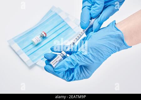 Arzt, Krankenschwester, Wissenschaftler, Forscher Hand in blauen Handschuhen mit Coronavirus, covid-19-Impfstoff-Krankheit Vorbereitung für menschliche klinische Studien Impfung Stockfoto