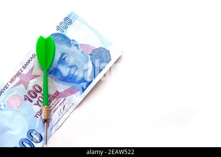 Investieren mit gelben, grünen und roten Darts und 100 türkische Lira auf weißem Hintergrund und türkische Lira für eine genaue Investition Stockfoto