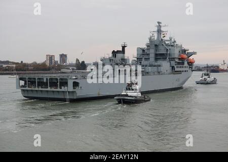 Schlepper führen das Royal Fleet Hilfsschiff ARGUS in Richtung der Marinestützpunkt Prinzessin Royal Jetty Stockfoto