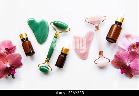 Face massage jade rollers on white background Stockfoto