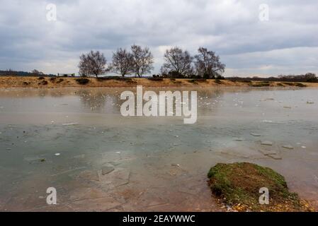 Frogham, Fordingbridge, Hampshire, UK, 11th Februar, 2021, Wetter: Nach einem starken Frost über Nacht sind die Temperaturen in der Mitte des Tages immer noch bei oder unter dem Gefrierpunkt. Ein Teich bei Abbots Well ist komplett gefroren. Kredit: Paul Biggins/Alamy Live Nachrichten Stockfoto